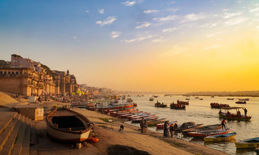 Varanasi ghats and boats on the Ganges in golden light