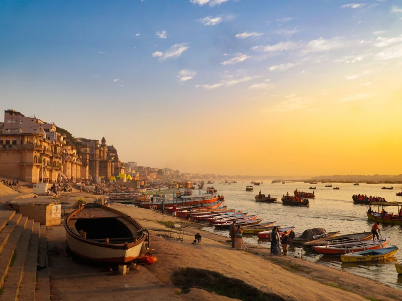 Varanasi ghats at sunset, with boats on the Ganges